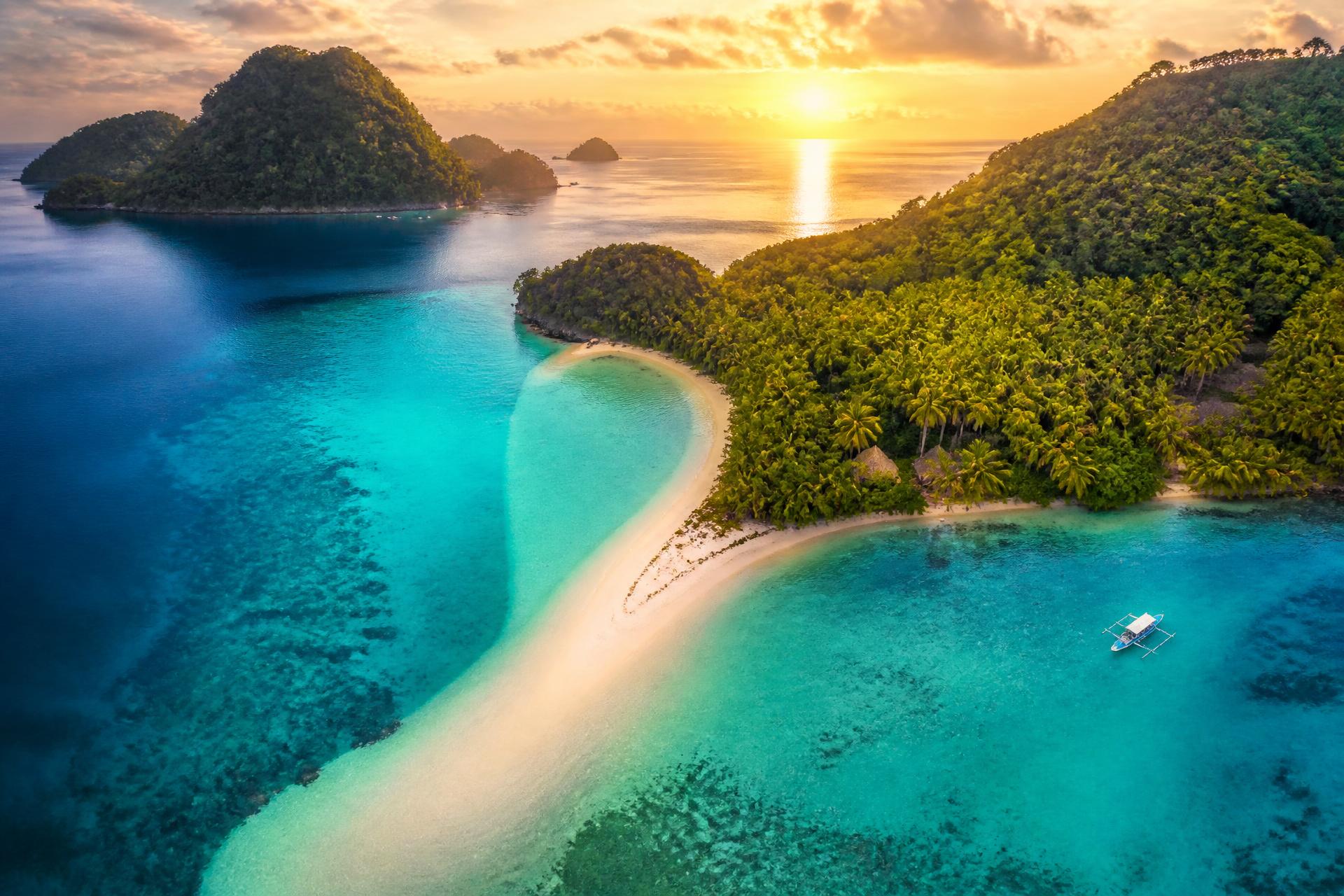 Aerial view of an Andaman island with turquoise water and white sand beach